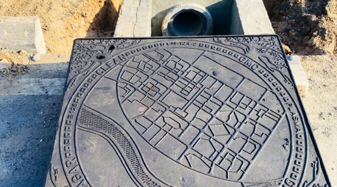 Gandhinagar sewer covers featuring a sectoral map of the city.