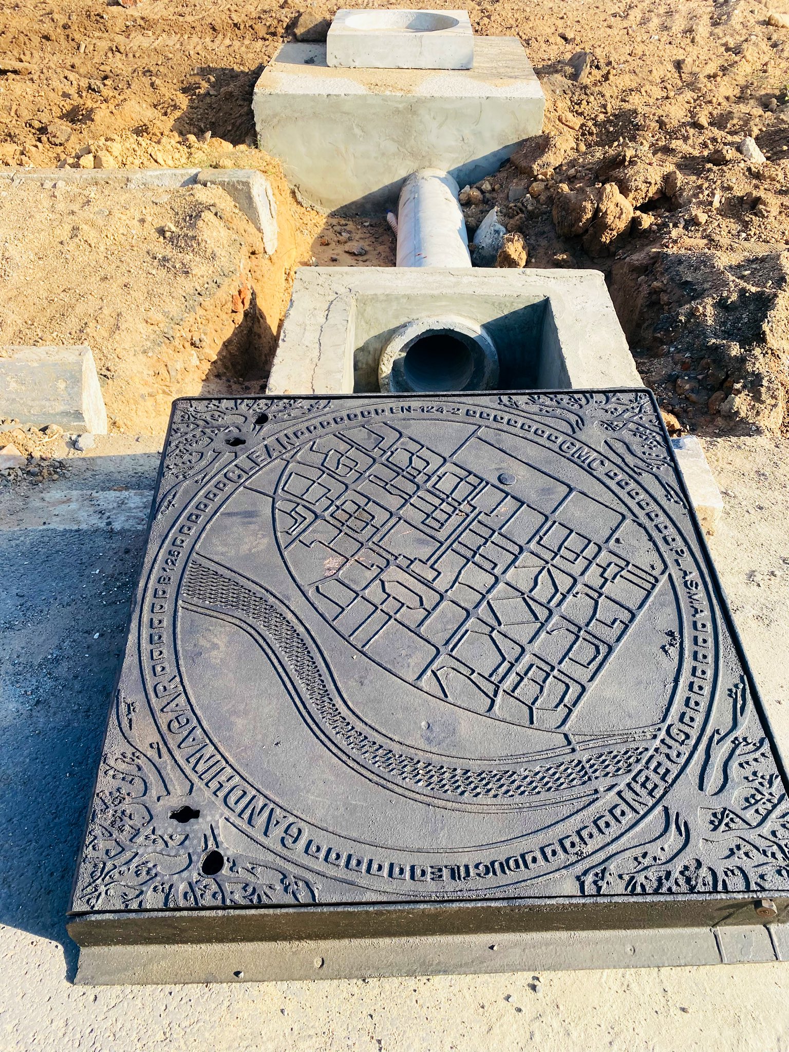 Gandhinagar sewer covers featuring a sectoral map of the city.